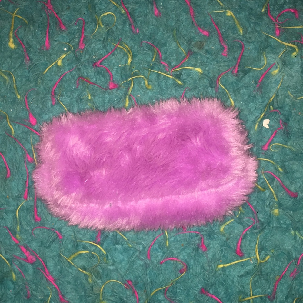 A fluffy purple zipper pouch